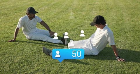 Cricket players sitting on grass chatting with social follower notification 50