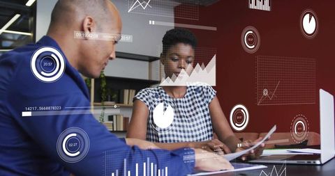 Collaborating on data dashboards, professionals analyzing reports with laptop and charts