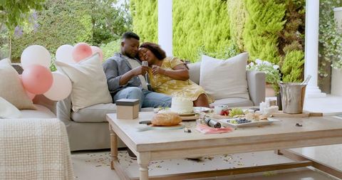 Relaxing Celebration on Patio with Joyful American Couple