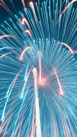 Launching firework shell bursting into layered blue and pink light trails vertical reel