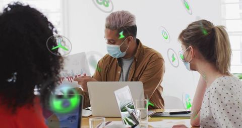 Team presenting energy data wearing masks in collaborative sustainability meeting