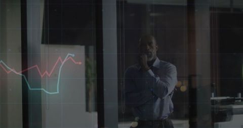 Executive Analyzing Financial Data on Transparent Display