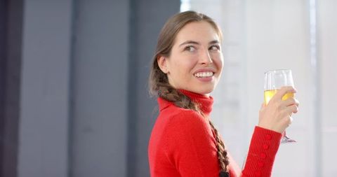 Woman Enjoying Refreshing Juice in Bright Domestic Setting