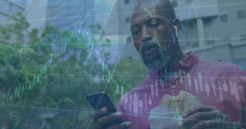 Man Engaged with Smartphone Amidst Financial Data Visualization