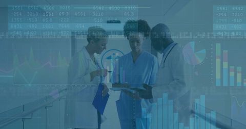 Doctors Analyzing Medical Data with Digital Charts in Hospital