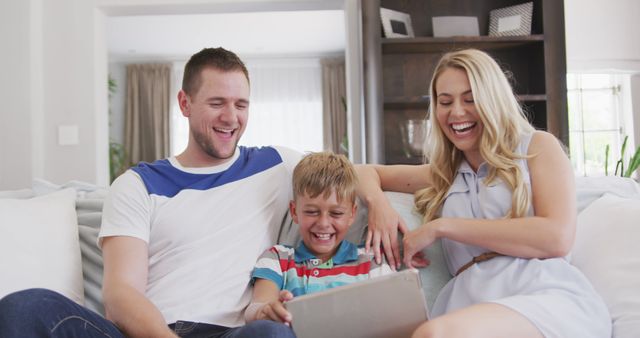 Smiling Family Enjoys Time Together with Tablet on Couch - Download Free Stock Images Pikwizard.com