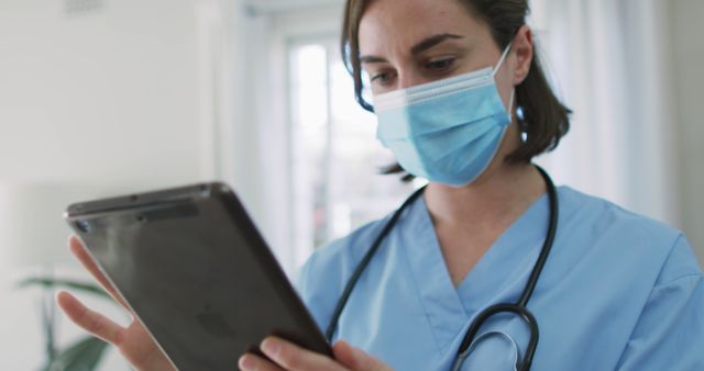 Healthcare Professional Using Digital Tablet Wearing Medical Mask - Download Free Stock Images Pikwizard.com