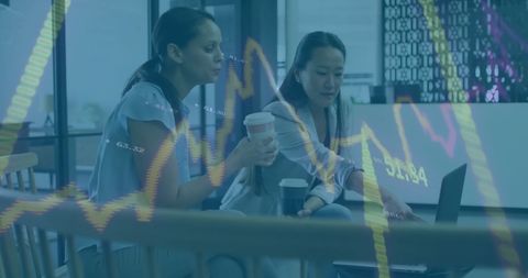 Diverse Female Professionals Analyzing Financial Graphs Office Data