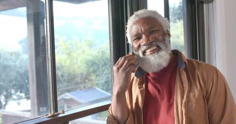 Senior African American Man Smiling by Home Window