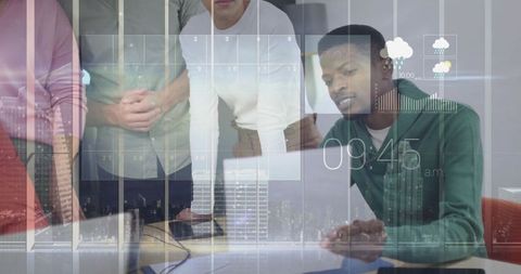 Diverse team collaborating over data visualizations on laptop