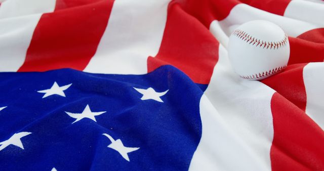 Showcases baseball on American flag symbolizing patriotism and national pride. Suitable for concepts related to American sports, Independence Day celebrations, American culture, and USA pride. Perfect for advertisements, editorials, and social media promoting American values and events.