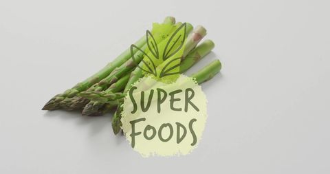Fresh Green Asparagus with Super Foods Label on White Background