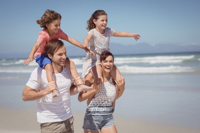 Cheerful family enjoying at beach during sunny day