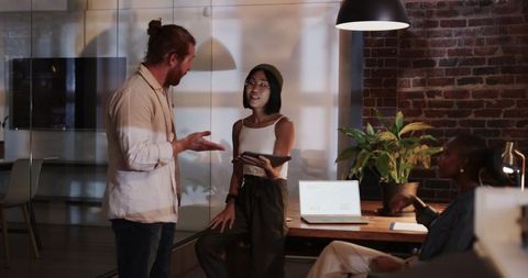 Diverse Team Collaborating in Modern Office at Night