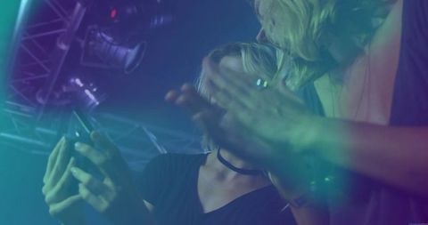 Women Enjoying Nightlife at Club with Haze and Lights