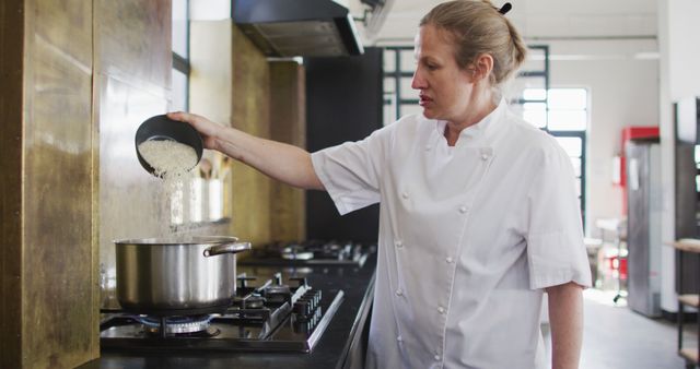 Female Chef Cooking and Pouring Rice into Pot in Restaurant Kitchen - Download Free Stock Images Pikwizard.com