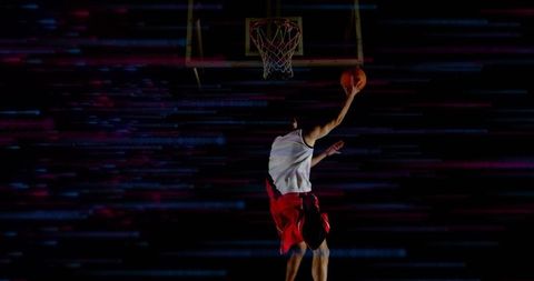 Basketball Player Dunking with Dynamic Neon Effects in Gym