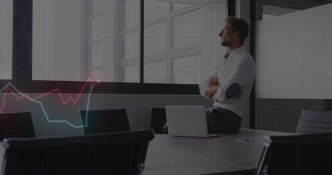 Businessman contemplating office with graph growth overlay