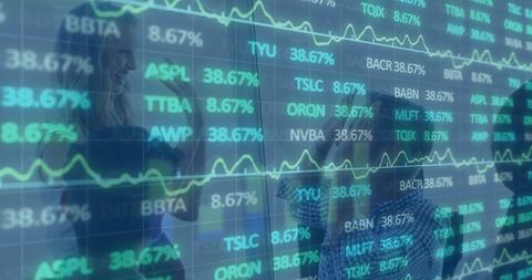 Colleagues Analyzing Digital Stock Market Charts in Office