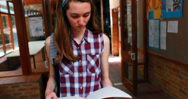 Teenage Girl Reading Book in School Hallway - Download Free Stock Images Pikwizard.com