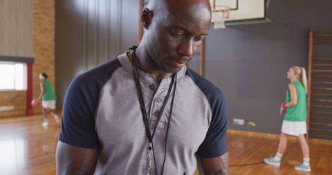 Basketball Coach with Female Team at Indoor Court