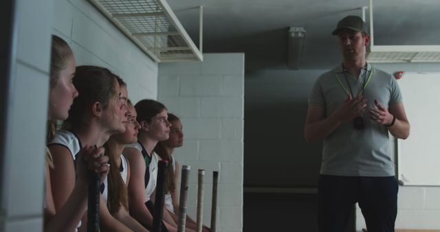 Coach Giving Team Talk to Field Hockey Players in Locker Room - Download Free Stock Images Pikwizard.com