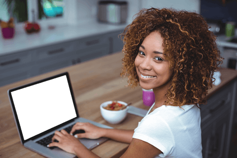Smiling Young Woman Using Laptop in Modern Kitchen Transparent Screen