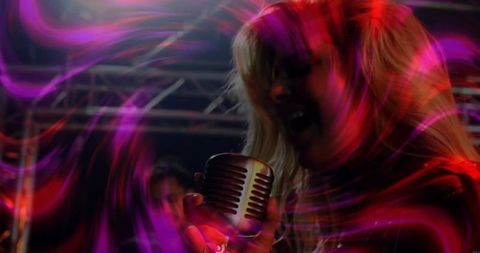 Vocalist Singing with Vintage Microphone on Colorful Stage