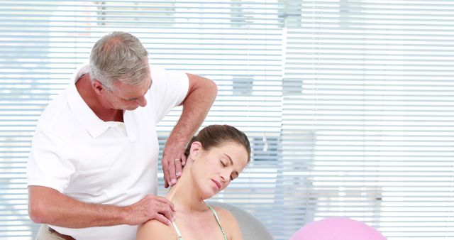 Chiropractor Treating Patient with Neck Pain in Modern Clinic - Download Free Stock Images Pikwizard.com