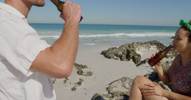 Young Couple Enjoying Refreshing Beers by the Beach - Download Free Stock Images Pikwizard.com