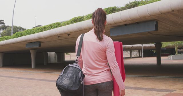 Active Woman Carrying Yoga Mat and Bag Outdoors - Download Free Stock Images Pikwizard.com