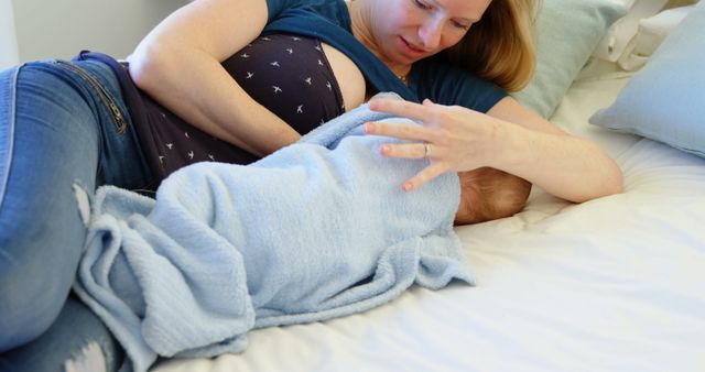 Mother breastfeeding infant on bed - Download Free Stock Images Pikwizard.com