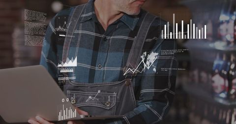 Warehouse Worker Using Laptop for Data Analysis