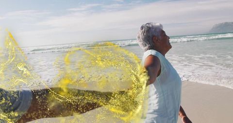 Senior woman holding partner's hand on serene beach with swirling golden effect
