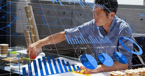 Architect Analyzing Graphs and Data in Modern Office - Download Free Stock Images Pikwizard.com