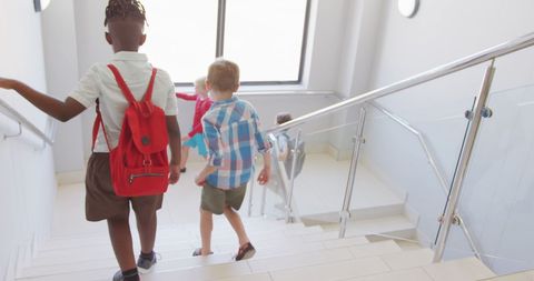 Diverse Boys Walking Down School Staircase