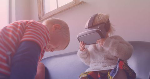 Children enjoying virtual reality technology in living room
