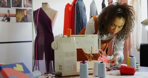 Fashion Designer Examining Cloth Samples in Creative Workshop