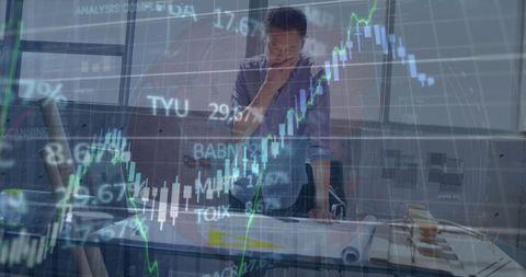 Businessman analyzing blueprint amid stock market graphics