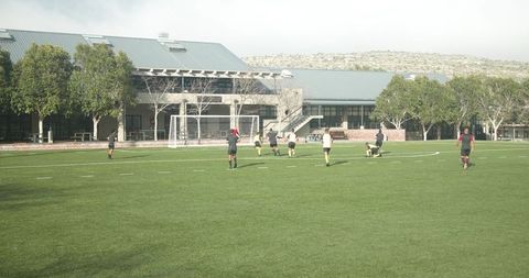 Youth Soccer Players Practicing on Field in Open Outdoor Setting