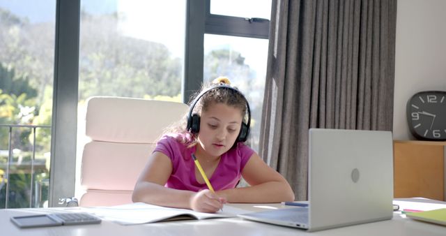 Young Girl in Headphones Studying at Home with Laptop - Download Free Stock Images Pikwizard.com