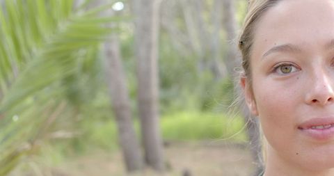 Half-Close Up of Young Reflective Woman Among Trees