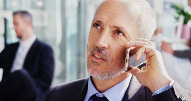 Businessman Communicating on Smartphone in Modern Office - Download Free Stock Images Pikwizard.com