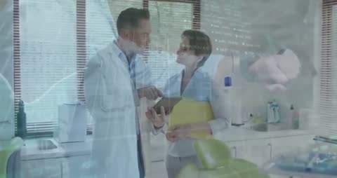 Doctors Analyzing Data Using Tablet in Modern Clinic