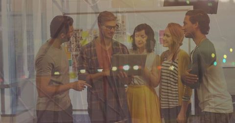 Office Team Collaborating with Stat Data Insights on Laptop Display