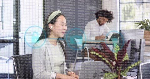 Smiling woman with headset collaborating in office with cybersecurity data overlay