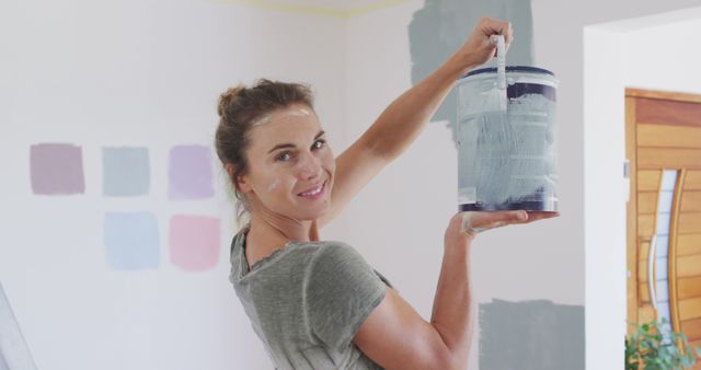 Smiling woman painting wall in modern home renovation - Download Free Stock Images Pikwizard.com