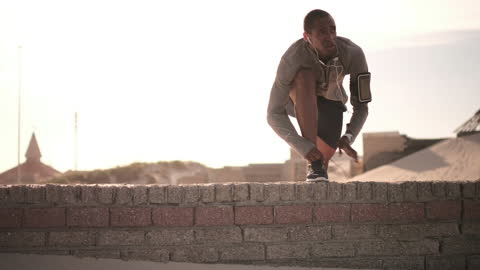 Man Tying Shoes Before Urban Run under Bright Sun
