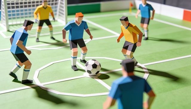 Paper soccer diorama featuring midfield battle between blue and yellow teams