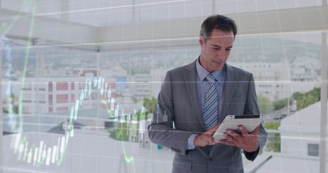 Business executive analyzing market data on tablet with city view and candlestick charts